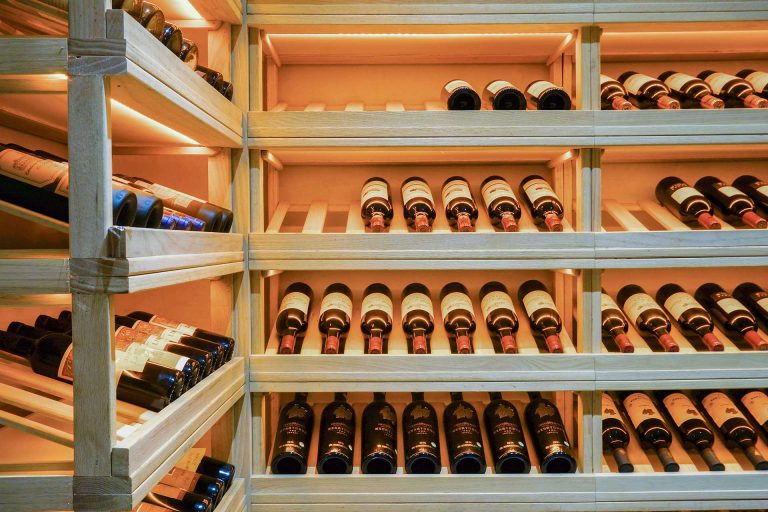 A beautifully illuminated wine room with custom-designed lighting that enhances both ambiance and preservation.