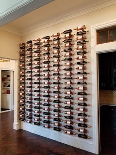 Luxury custom wine room with elegant lighting designed by Amaya.